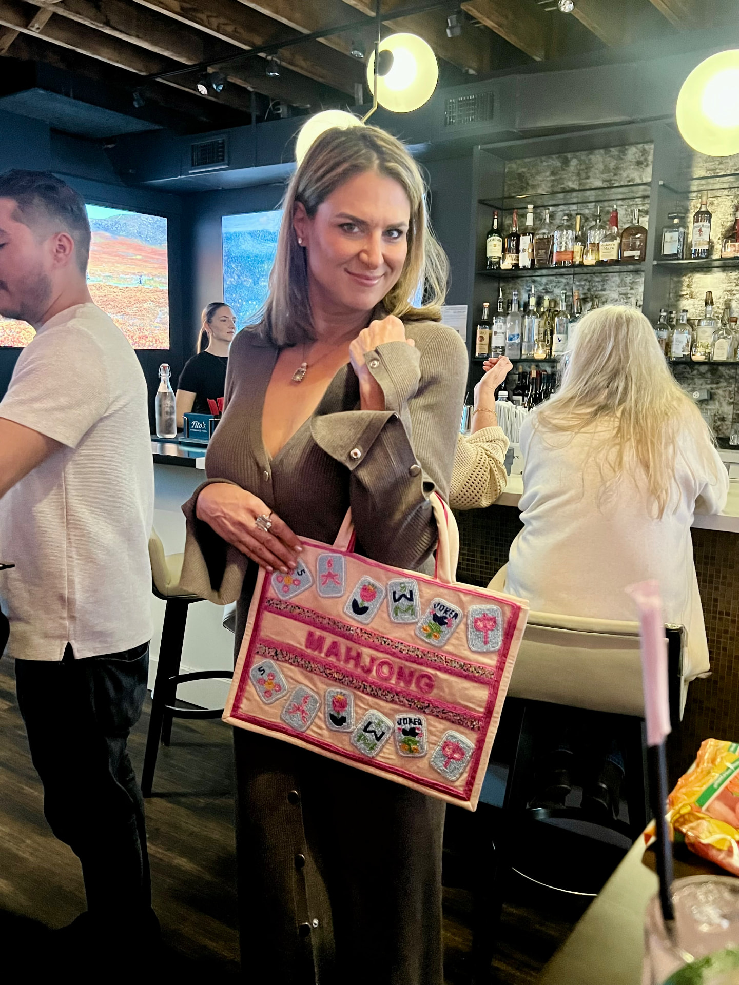 A friend carrying a mahjong tote on a night out